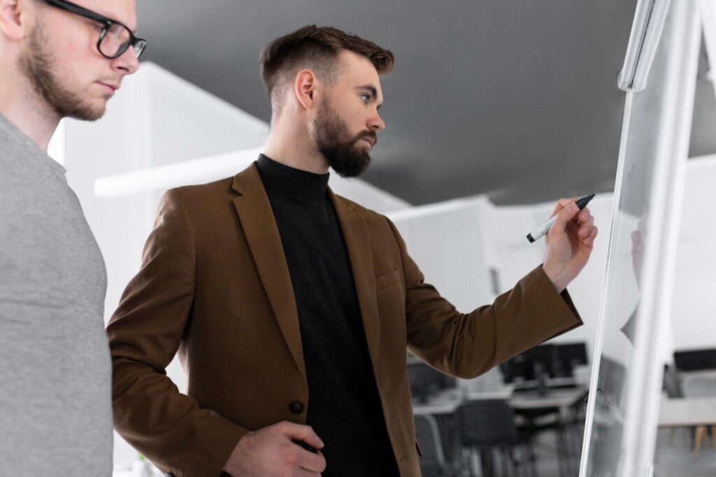 A one-on-one coaching session between a sales coach and an employee