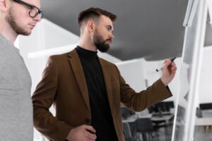 A one-on-one coaching session between a sales coach and an employee