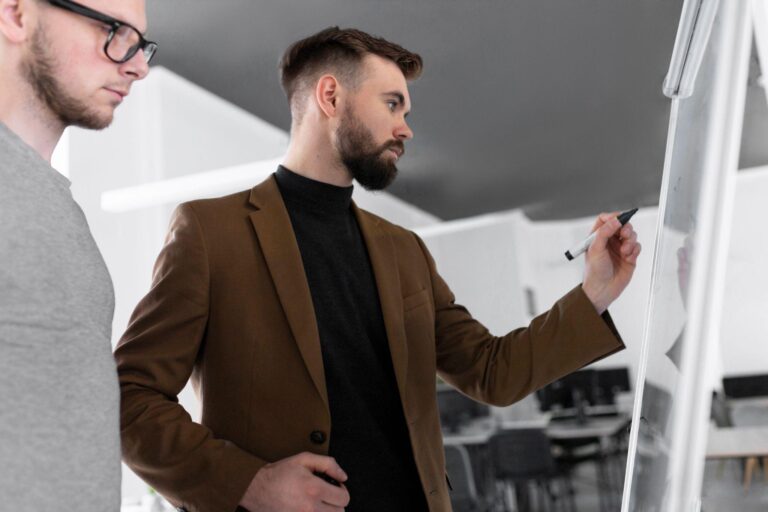 A one-on-one coaching session between a sales coach and an employee