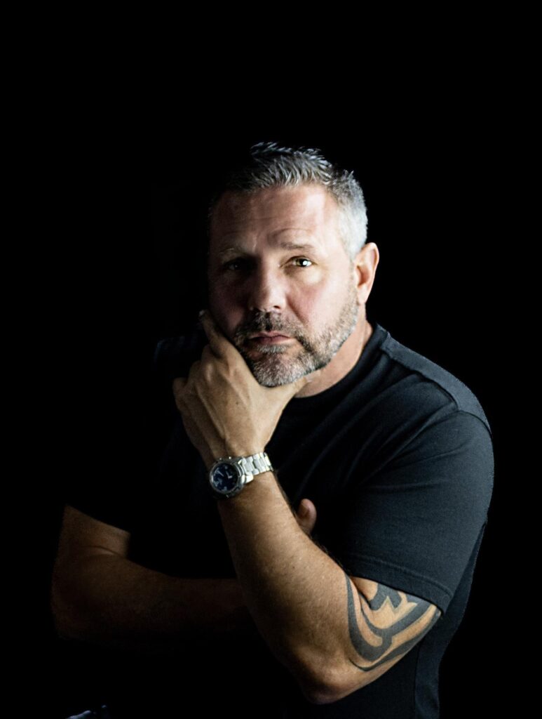 A professional headshot of Joseph Drolshagen