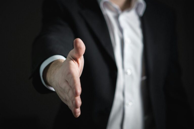 A man extending his hand for a handshake