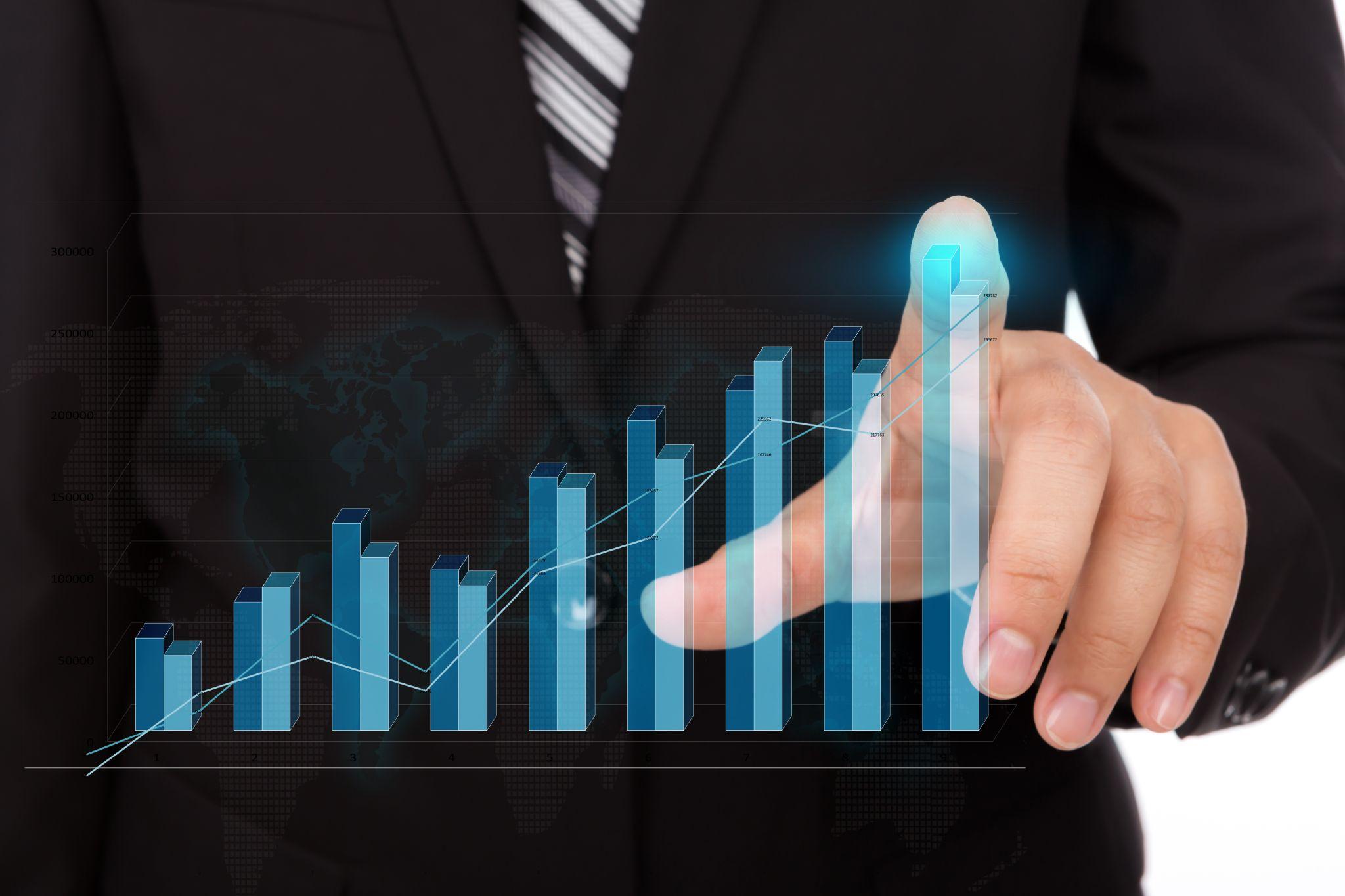 A man presenting a graph with an upward trend to illustrate business profit growth.