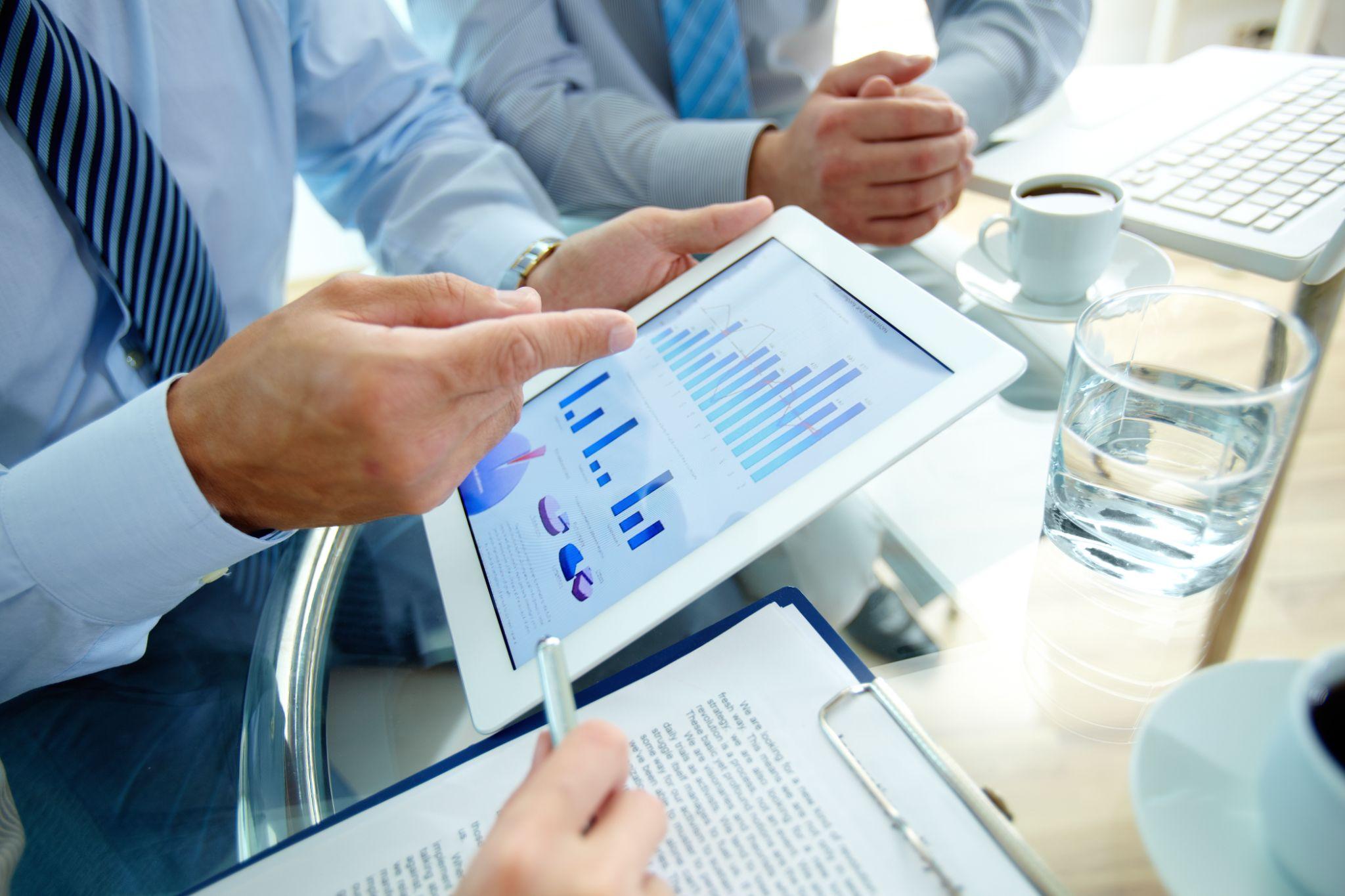 A group of professionals discussing annual revenue growth strategies.