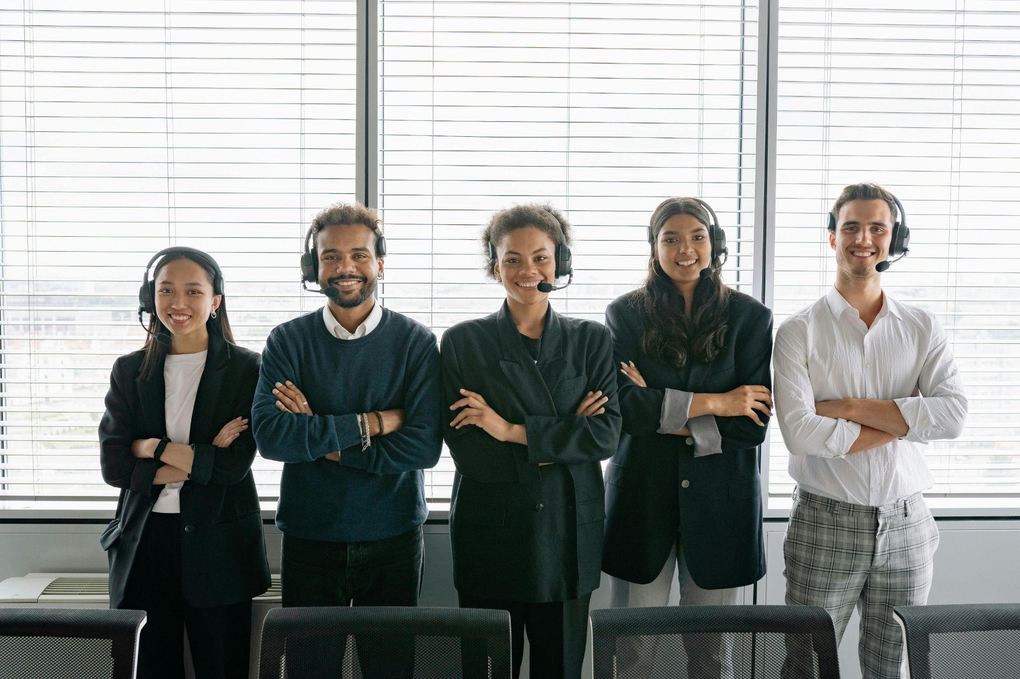 A sales team standing together, smiling confidently.